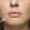 Close-up portrait of young woman on white studio background. Filling surgery procedure. Lip augmentation. Concept of women's health and beauty, cosmetology, self-care, body and skin care. Anti-aging.